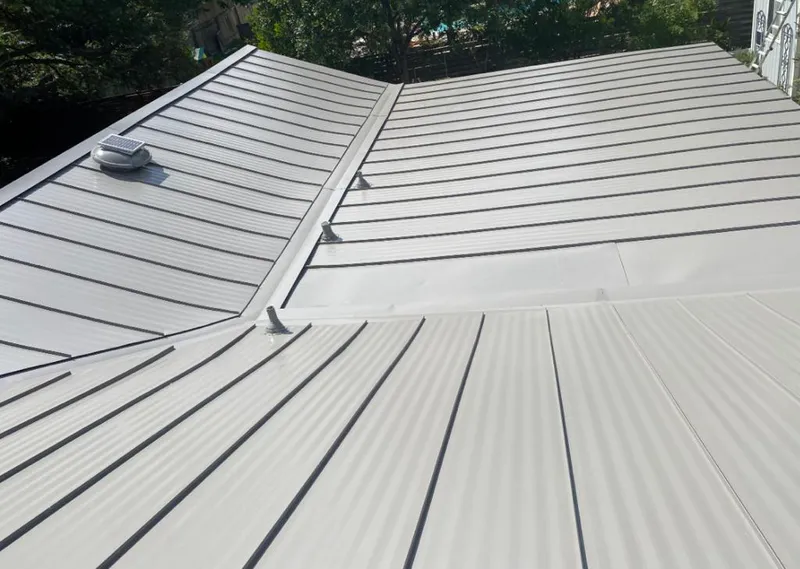 Solar attic fan installed on a metal roof for Roof Ventilation in Hoboken